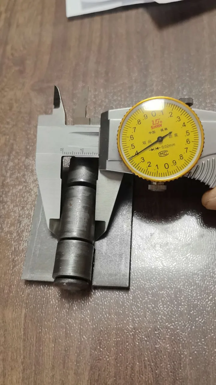 Caliper checking a gate hinge in a Kenya hardware shop